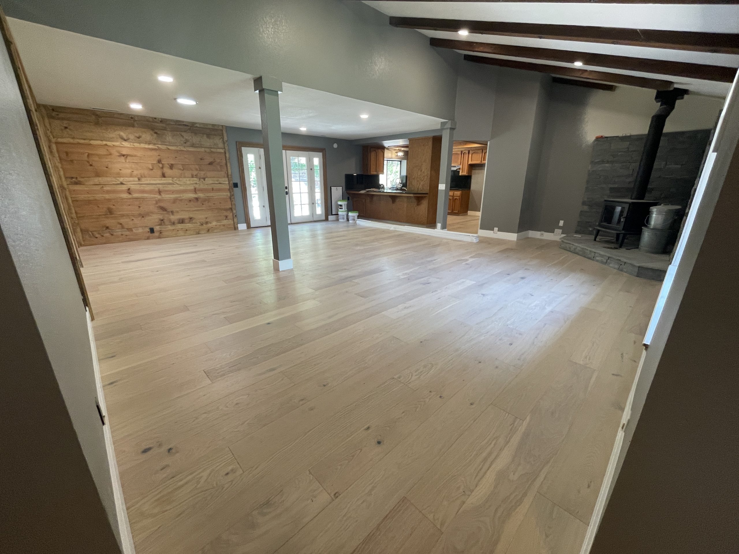 Home's hardwood flooring done in a large living room